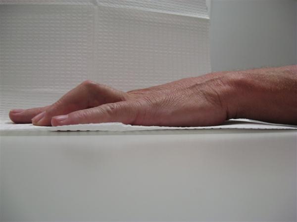Table top test: hand placed flat on a table to check whether the fingers can lie straight