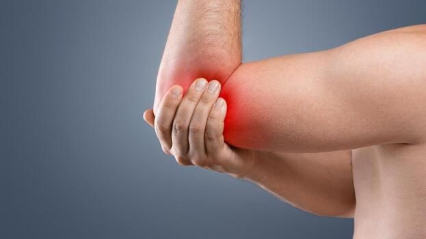 Man holding a painful elbow