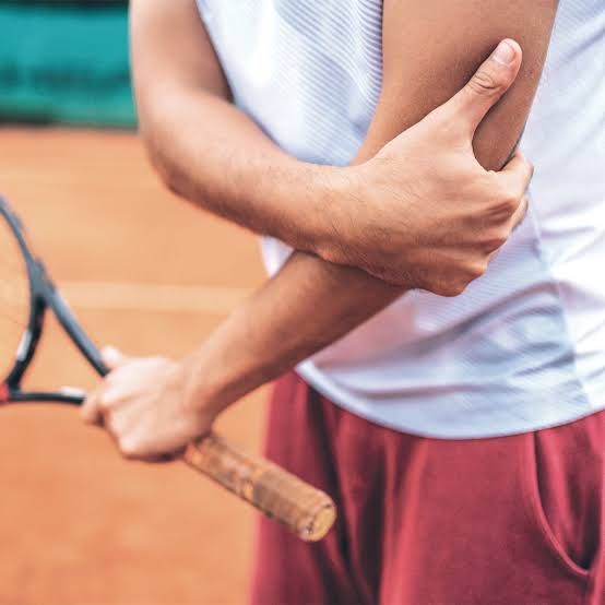 Tennis racket and the outer elbow, where tennis elbow pain is felt